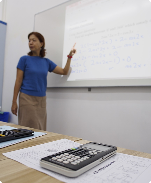 Mrs Debbie Wong teaching Additional Mathematics at the whiteboard