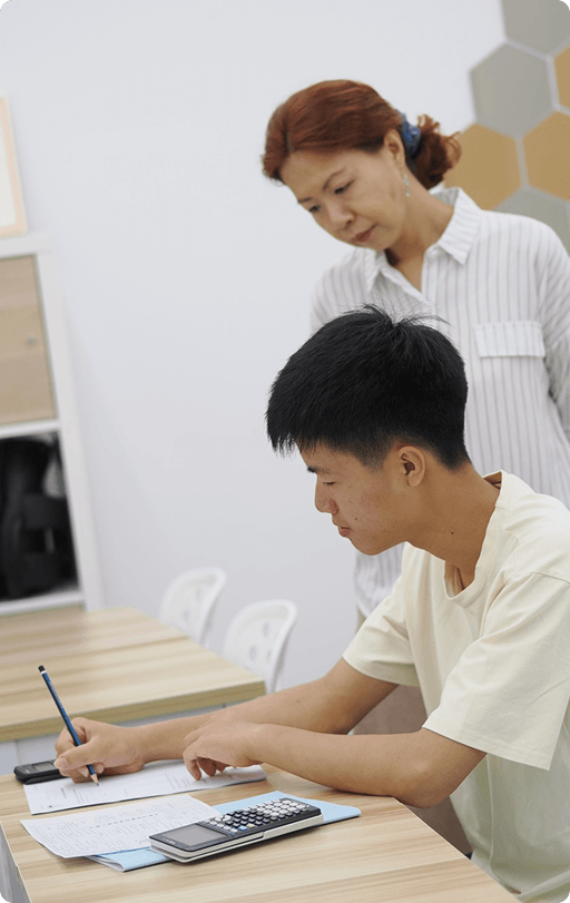 Mrs Debbie Wong guiding a student through Additional Math problems