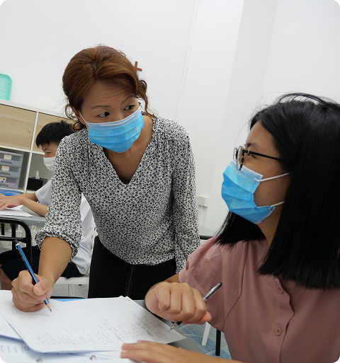 Mrs Debbie Wong giving individual guidance to a student