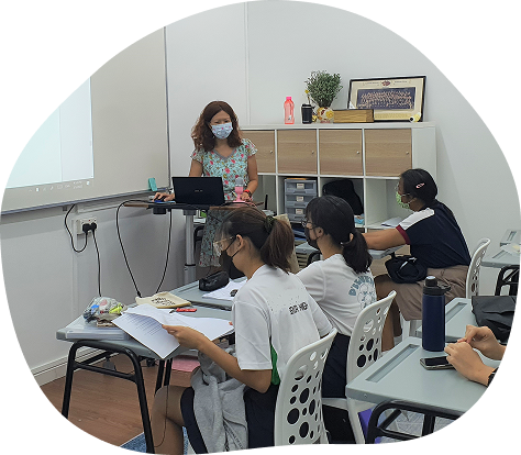 Mrs Debbie Wong teaching a small Additional Math class